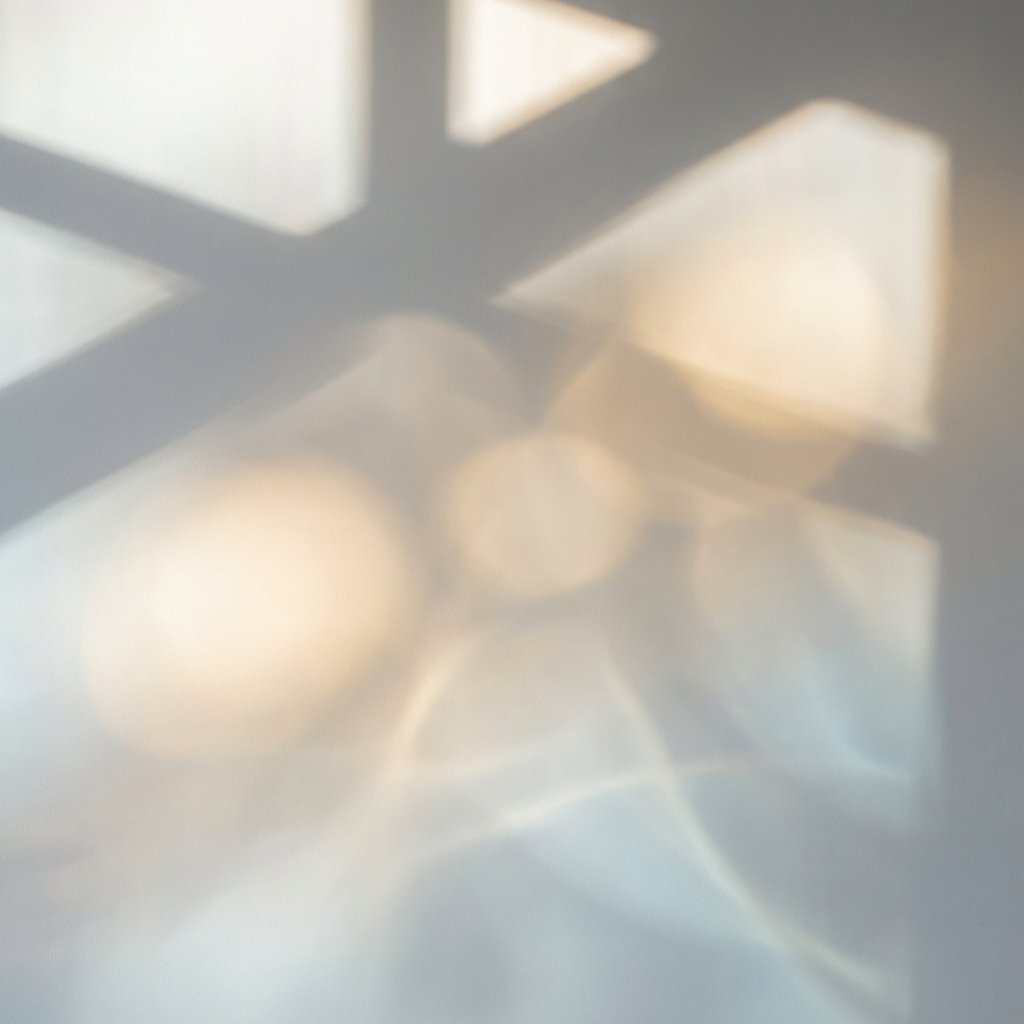 Soft, abstract light and shadow patterns are cast on a pale surface, with blurred, overlapping circles and geometric shapes creating a calm, ethereal effect. {{brizy_dc_image_alt imageSrc=